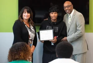 Mus Ta Fa poses for a photo with Allen Superior Court Judge Andrea Trevino, left, and Joe Jordan, president and CEO of Boys & Girls Clubs of Fort Wayne, during a ceremony to celebrate the partnership between The Boys & Girls Clubs of Fort Wayne Jim Kelley Career Pathway Center and the Allen County Juvenile Probation division at the center on Thursday afternoon.